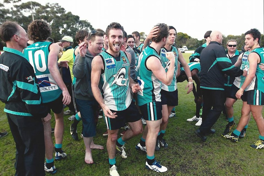 Albany footballer Jake Stuart celebrates with his teammates after the club's one and only victory.