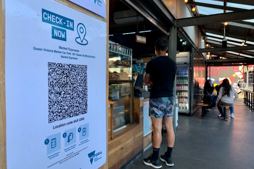 A QR code check in sign at a cafe