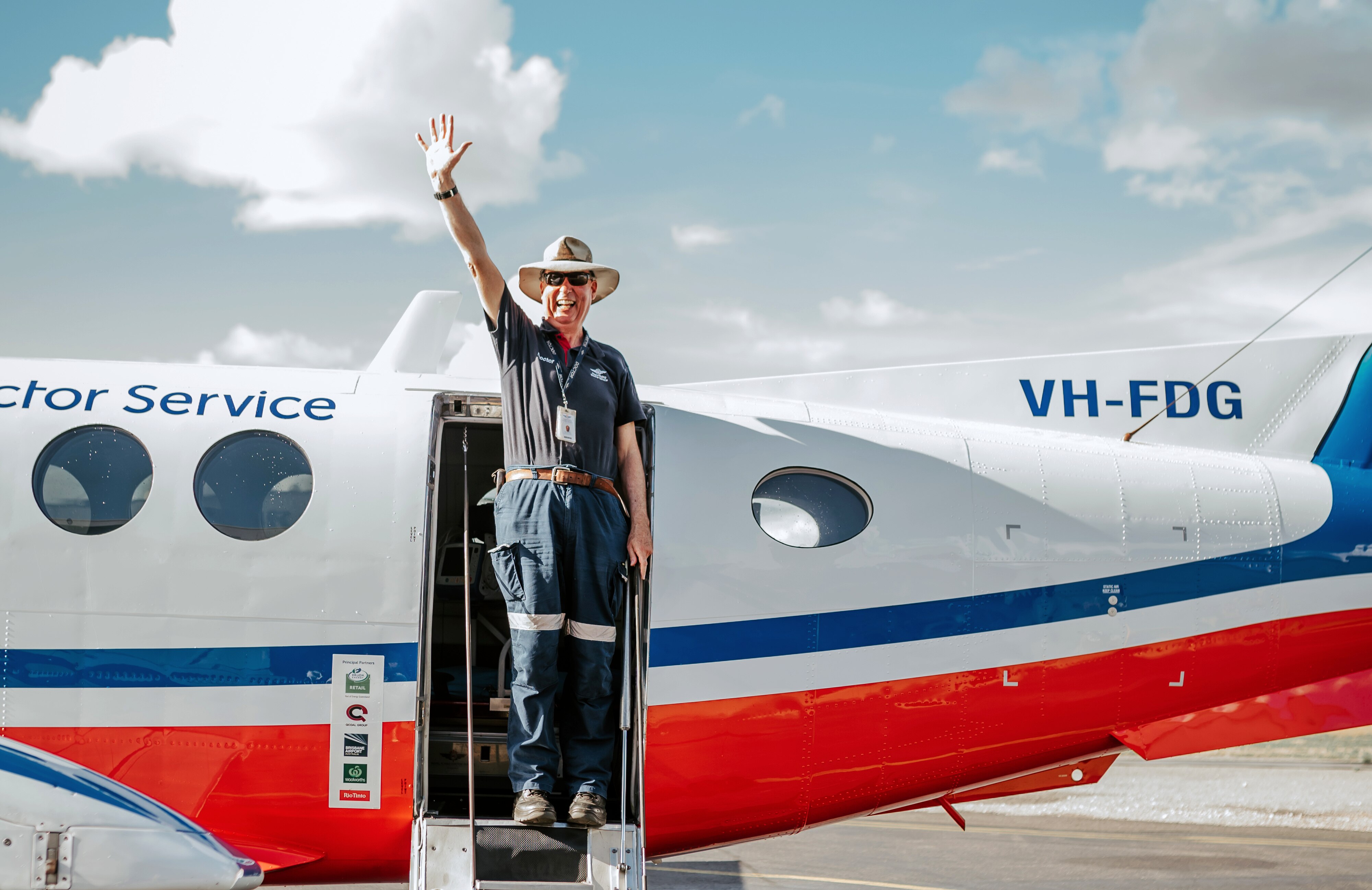 A medical officer waves from an RFDS plane