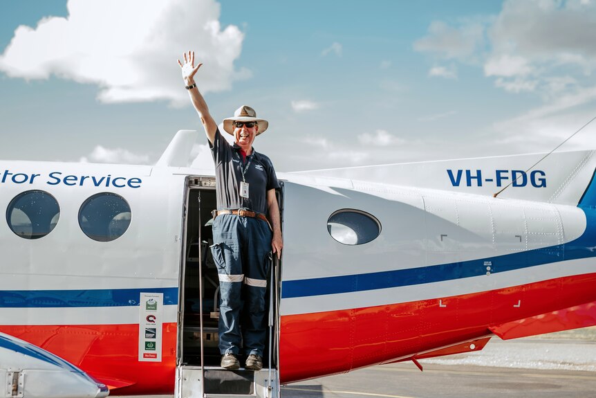 A medical officer waves from an RFDS plane