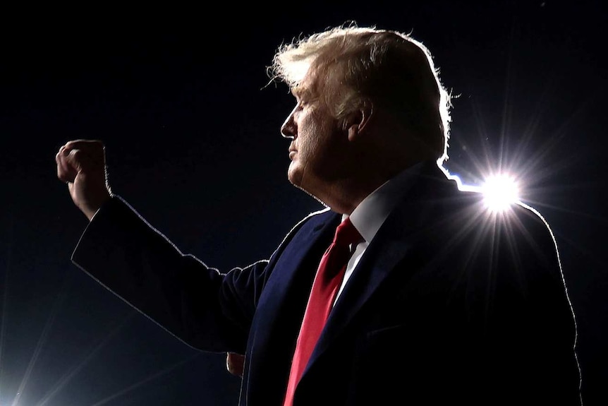 US President Donald Trump gestures as he departs after a campaign