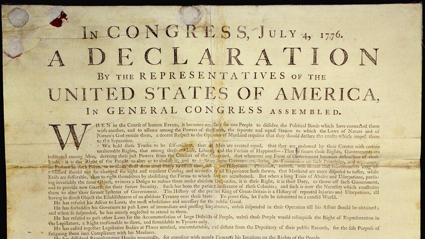 Browning, creased paper with faded printing of Declaration of Independence