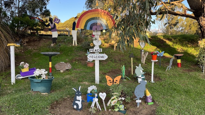 a selection of cut out woodwork Australian animals nestled into a roadside verge garden. 