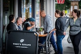 Patrons sit outside a busy cafe in Sydney.