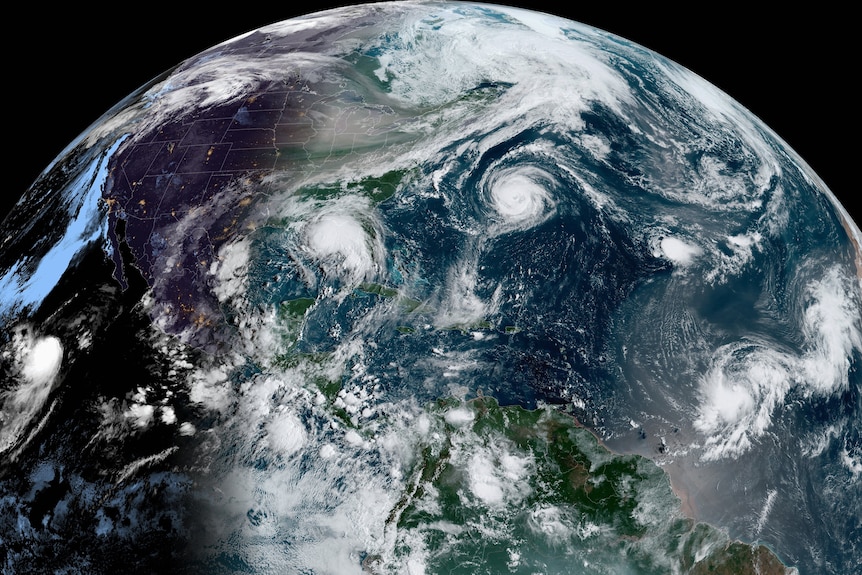 A GOES-16 GeoColor satellite image showing five storms spinning in the Atlantic Basin in 2020