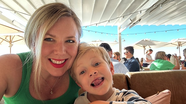 Gayle Dickerson takes a selfie with her son at a cafe table
