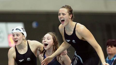 Maddison Elliot (centre) celebrating with team mates as they take out the gold medal in the Women's 4x100m freestyle relay.