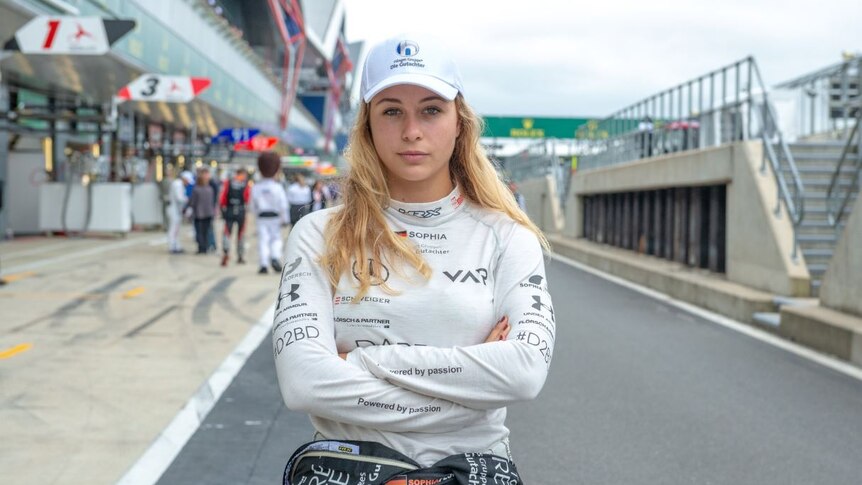 A young woman with blonde hair and a look of determination.