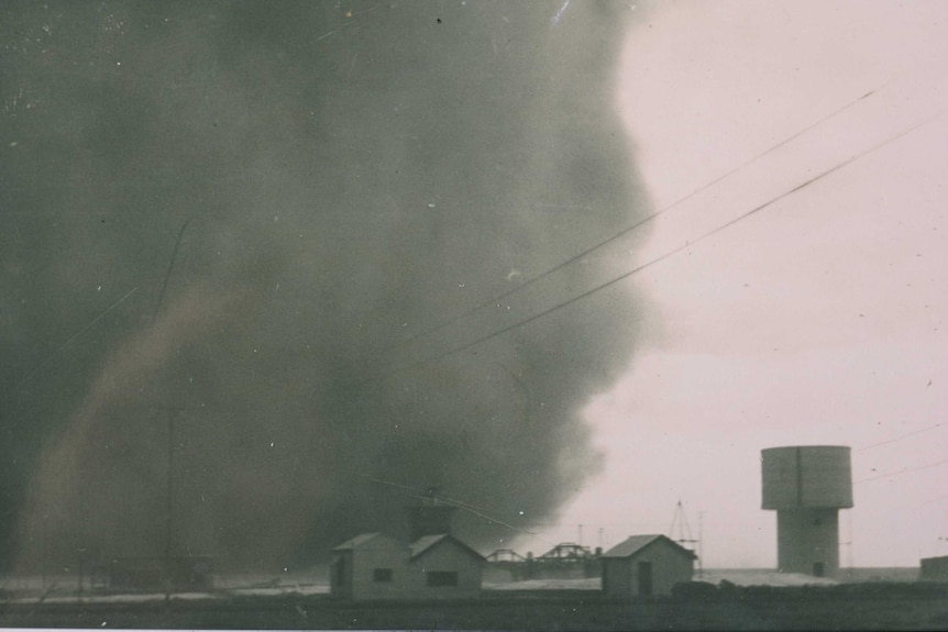 A dust storm arrives at a small town on the Nullarbor