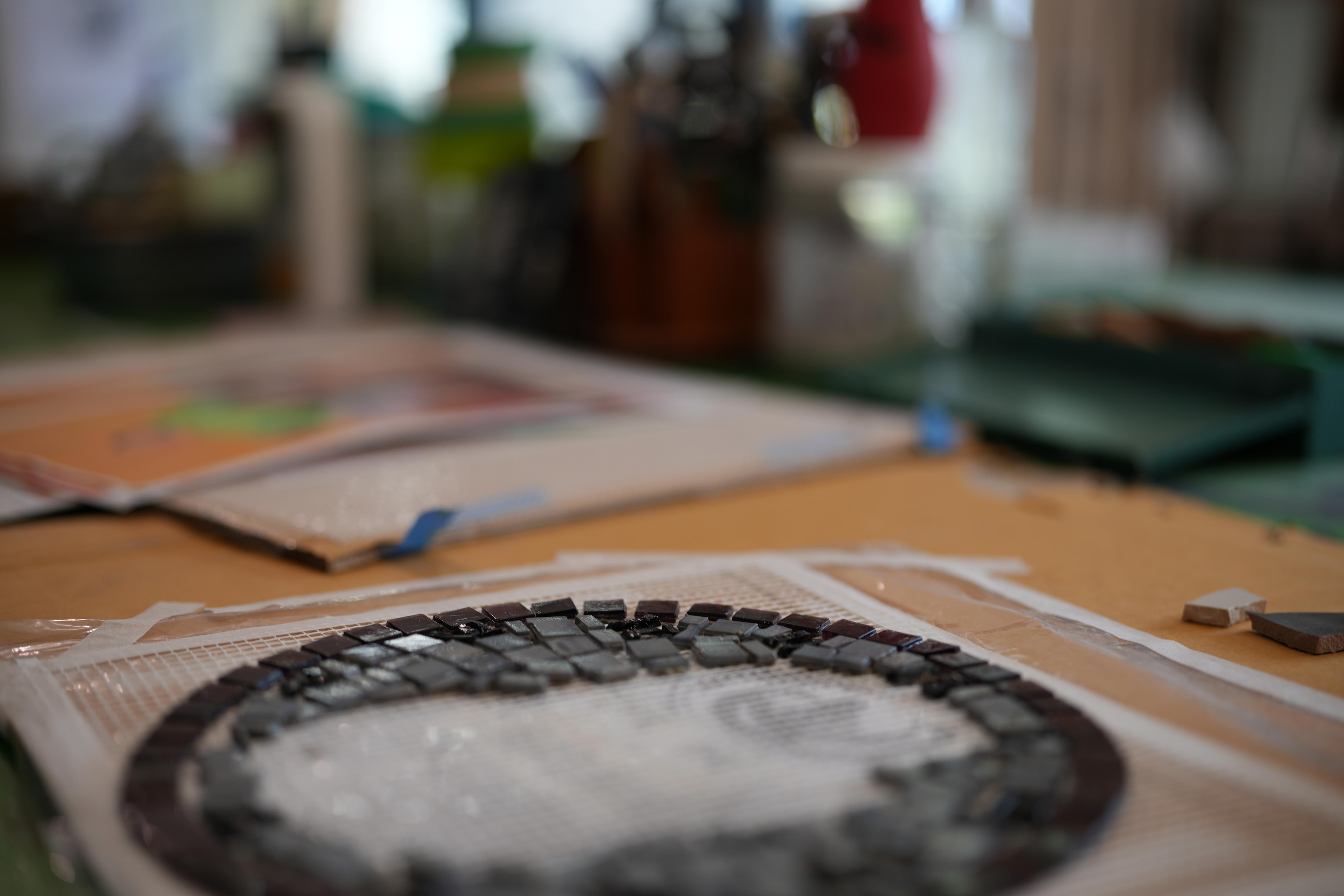 Close up of mosaic tile project on work bench