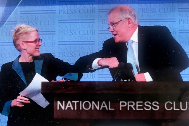 Lane doing elbow bump with Prime Minister Scott Morrison at Press Club lunch.