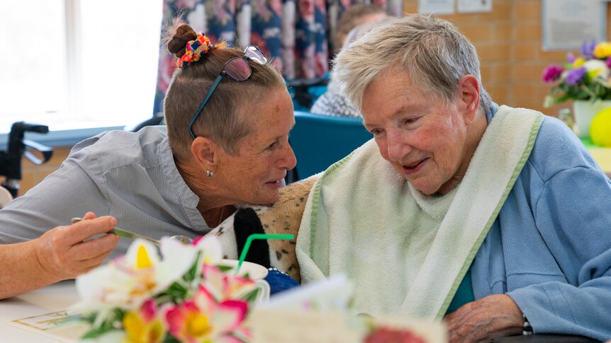 Registered nurse Penny Abbington feeds an aged care resident