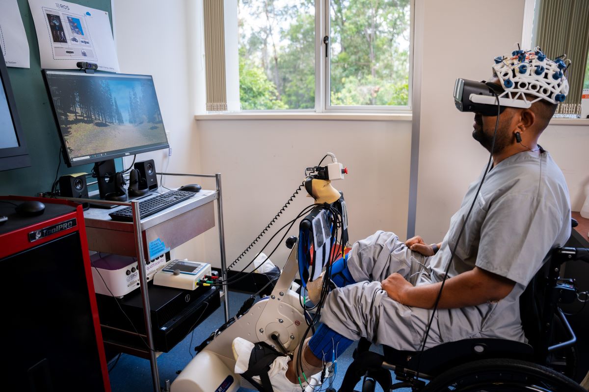 A man hooked up to VR headset