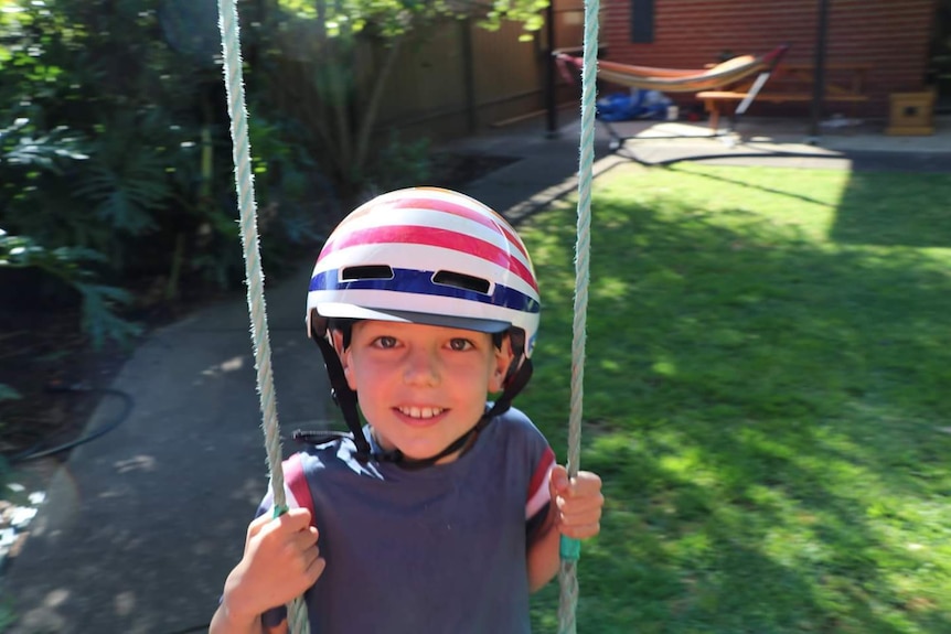 Patch wearing a helmet on a swing