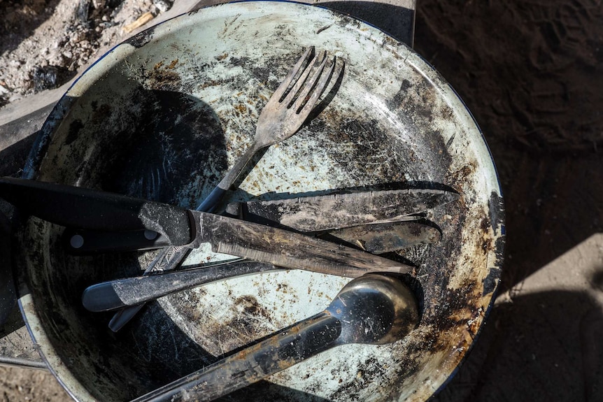 A frypan and cutlery at the camp