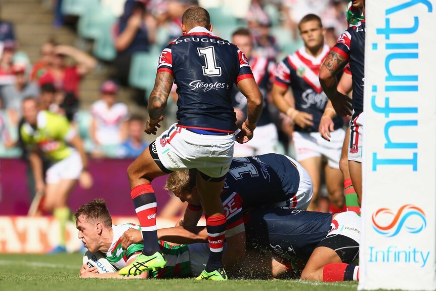 Cameron McInnes (L) scores a try for South Sydney against Sydney Roosters on March 6, 2016.