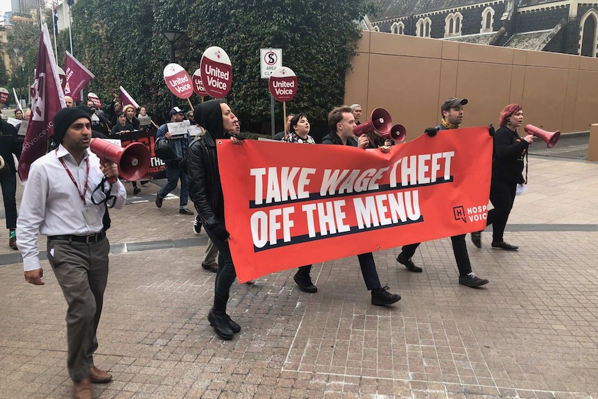 Protesters rally against underpayment in the hospitality industry outside the Restaurant Leaders Summit in Melbourne.