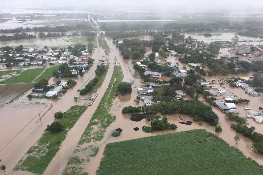 Aerial photo of floodwaters covering the streets and low-lying areas of Giru.