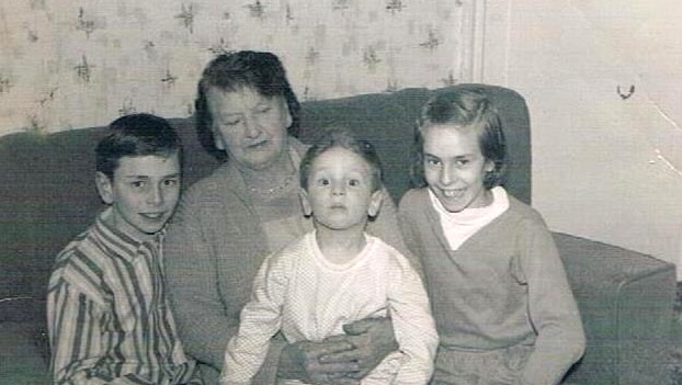 A black and white photo of Paul Gilmore with his family.