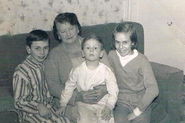 A black and white photo of Paul Gilmore with his family.