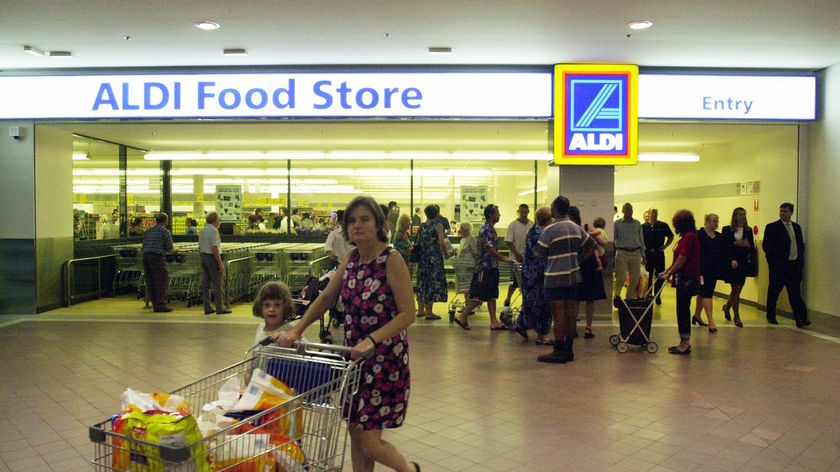 A shopper walks past an Aldi supermarket in Sydney, 2001