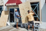 Preparing for Irene: Two men board up windows at Atlantic Beach, North Carolina.