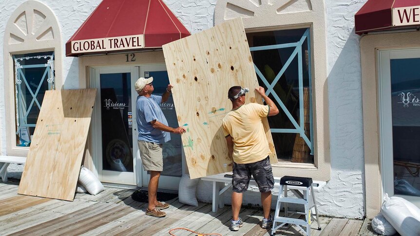 Preparing for Irene: Two men board up windows at Atlantic Beach, North Carolina.