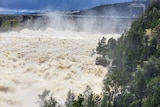 waters gushing from a dam