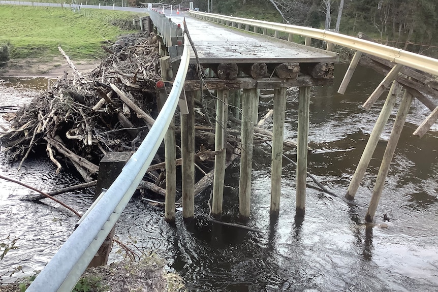 Debris and damage to a bridge across a river