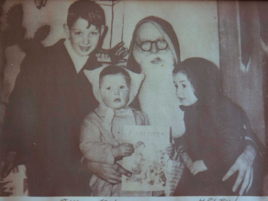 A photo of Helen and her siblings with Santa.