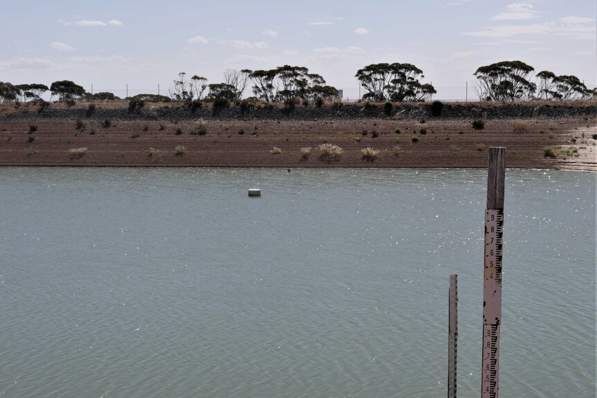A dam in the middle of an outback setting