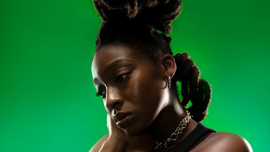 Picture of Little Simz against a green background
