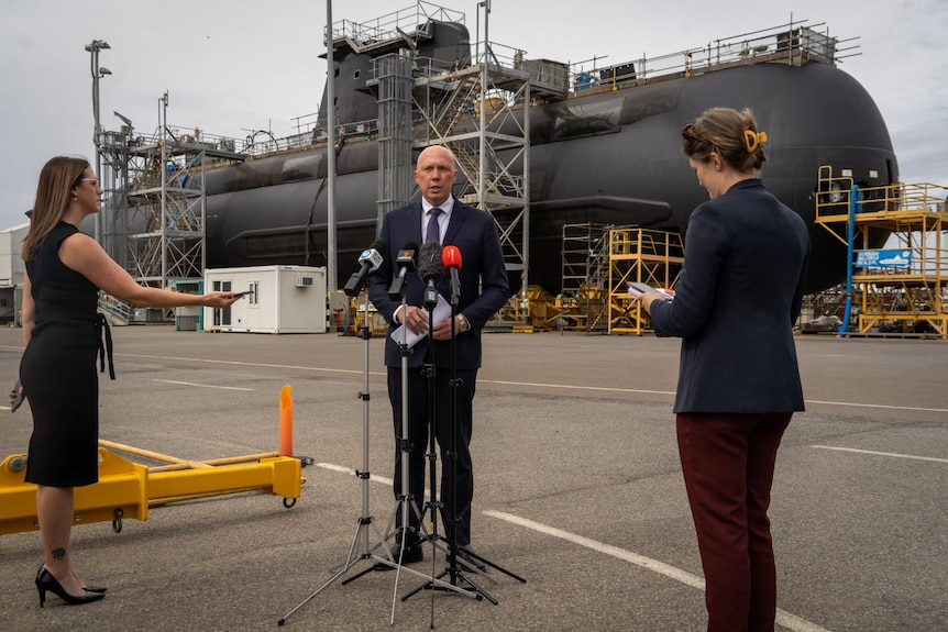 Defence Minister Peter Dutton in front of a Collins Class submarine at the Osborne facility. 