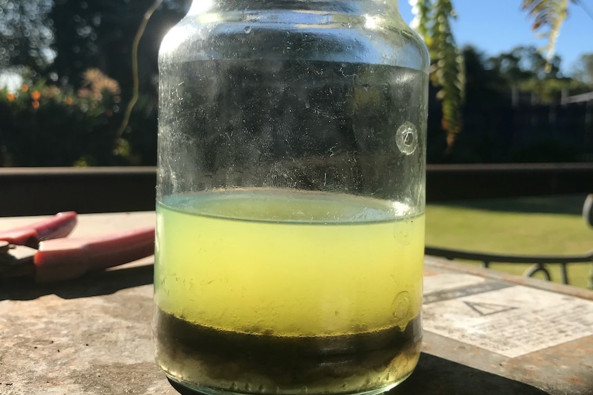 Jar of fuel with water in it