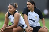 Lauren James and Sam Kerr sit together during a Chelsea training session