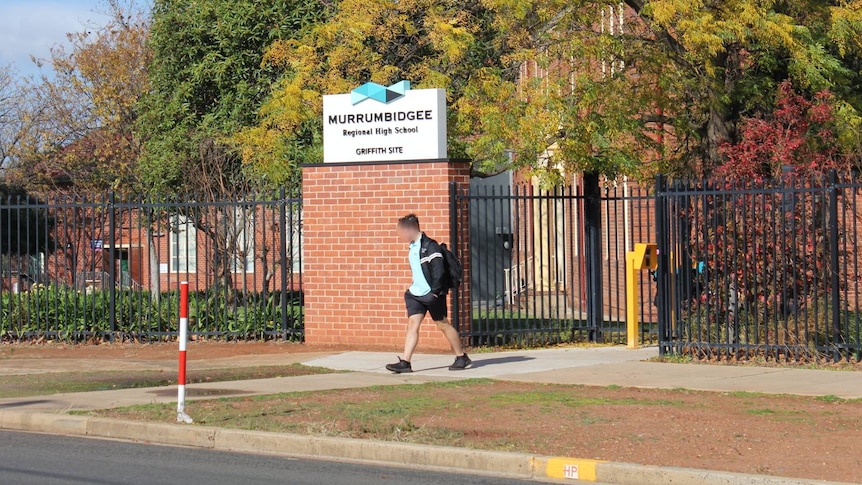 Image of high school with student exiting.