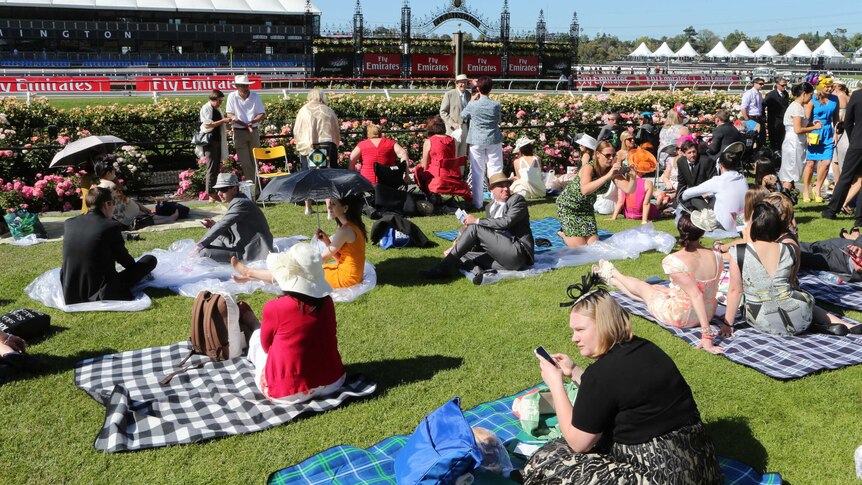 Punters arrive early to take up the best positions at Flemington racecourse on Melbourne Cup day.