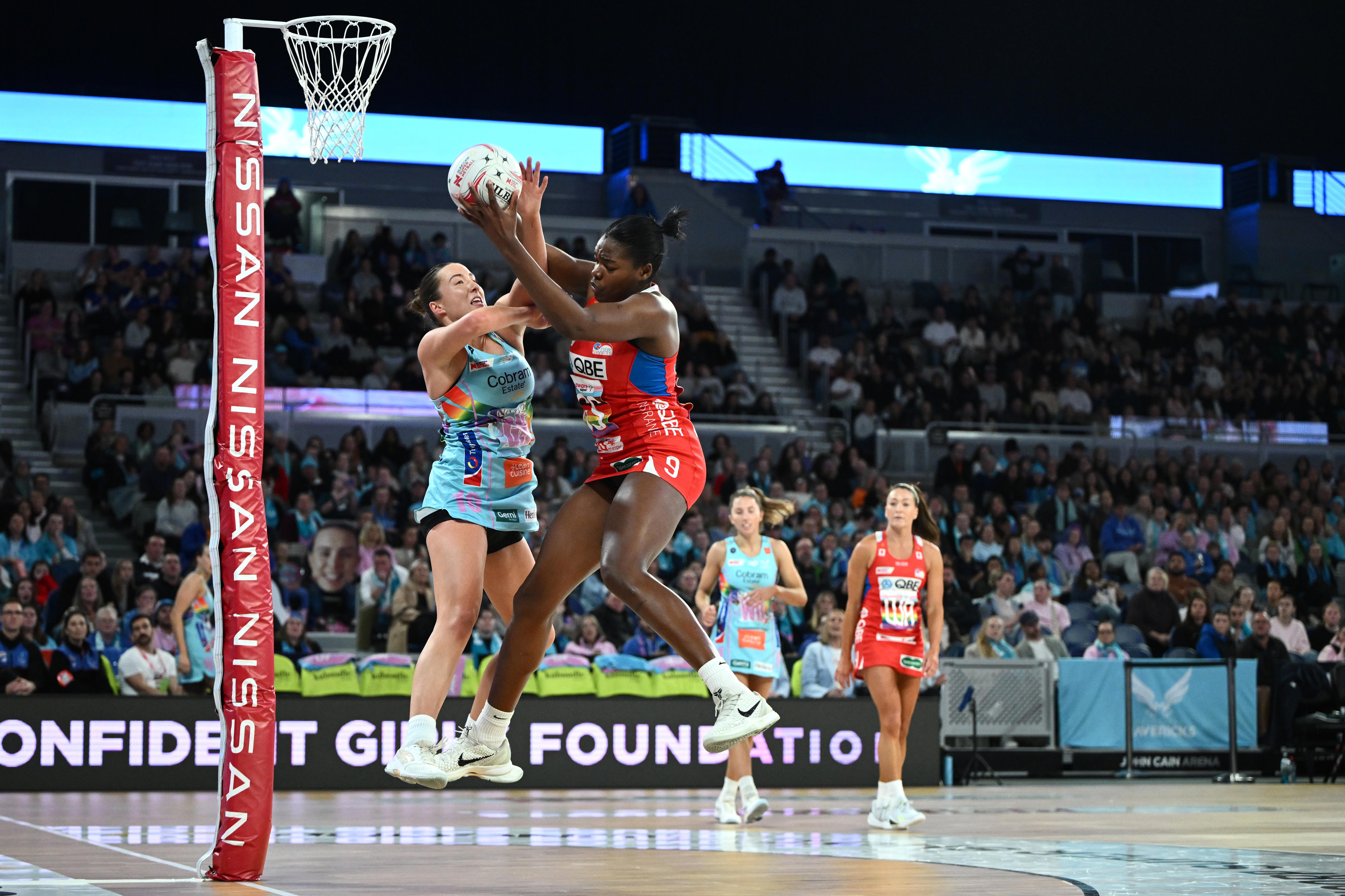 Two players fly high in the air as they contend a pass