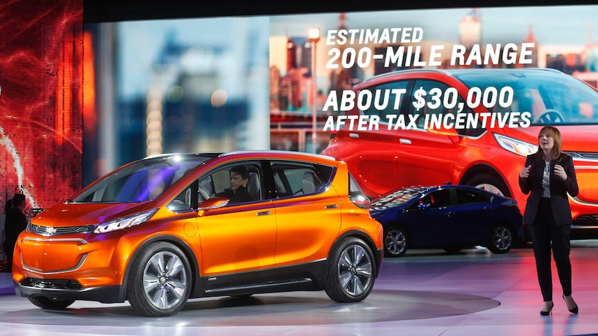 General Motors CEO Mary Barra speaks next to the Chevrolet Bolt EV electric concept car (L) and the 2016 Chevrolet Volt hybrid (rear) after they were unveiled during the first press preview day of the North American International Auto Show in Detroit, Michigan January 12, 2015.