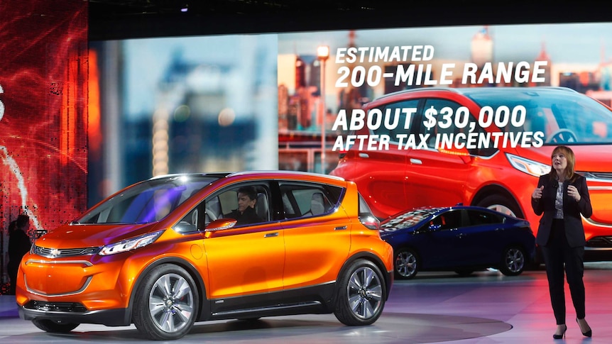 General Motors CEO Mary Barra speaks next to the Chevrolet Bolt