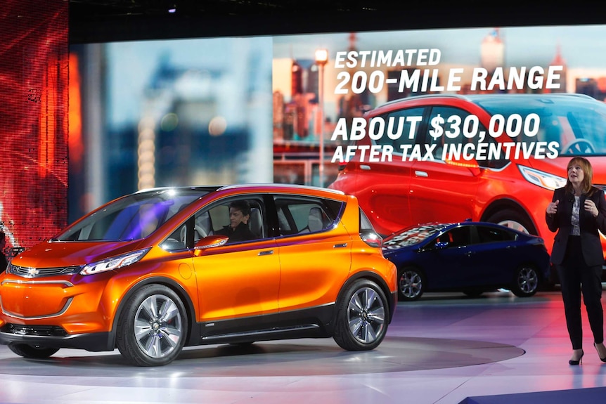 General Motors CEO Mary Barra speaks next to the Chevrolet Bolt