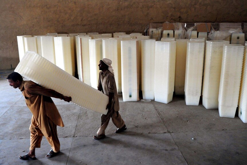 Pakistani workers in Karachi carry ballot boxes ahead of the May 11 elections.