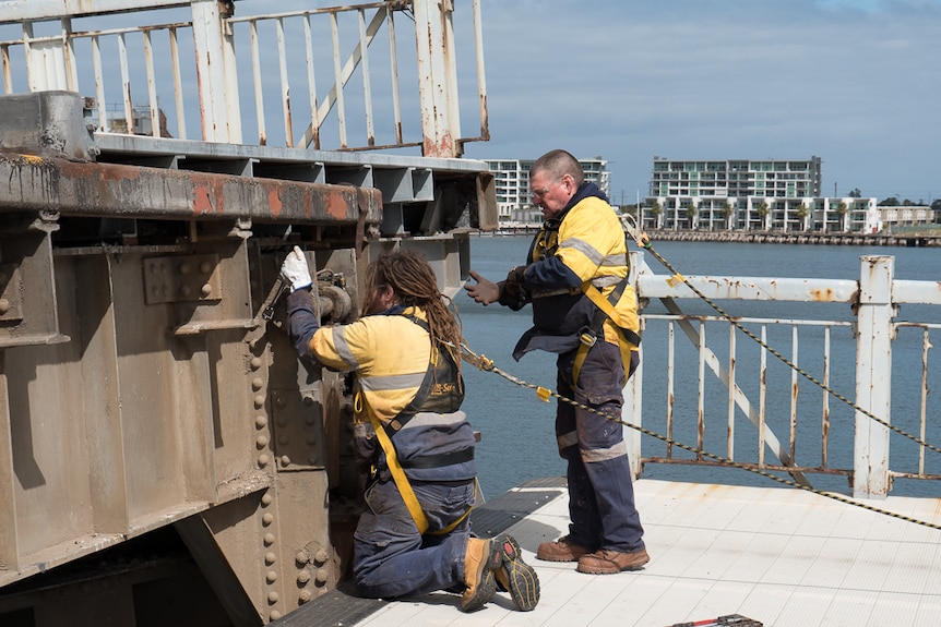 Chris Macintyre and Ian Thomson carry out maintenance on the bridge.