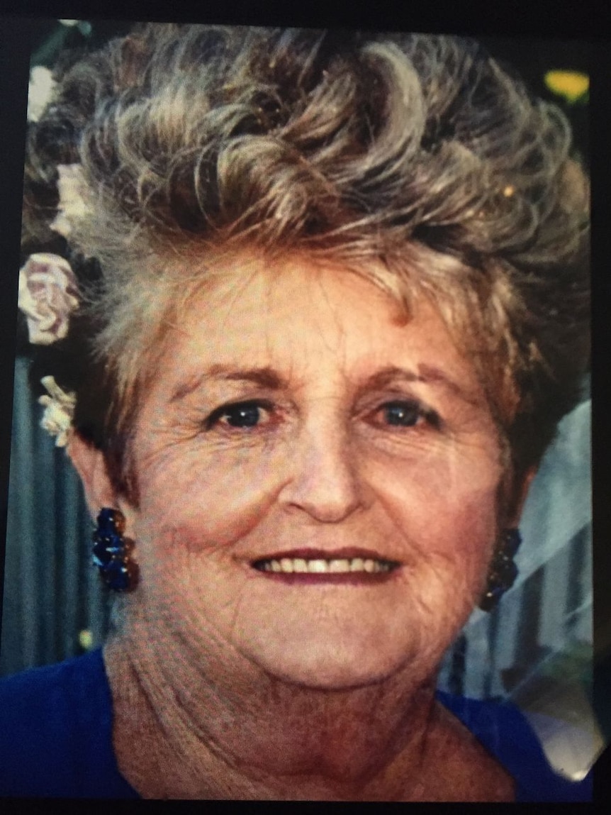 Close up of elderly woman with flowers in her hair