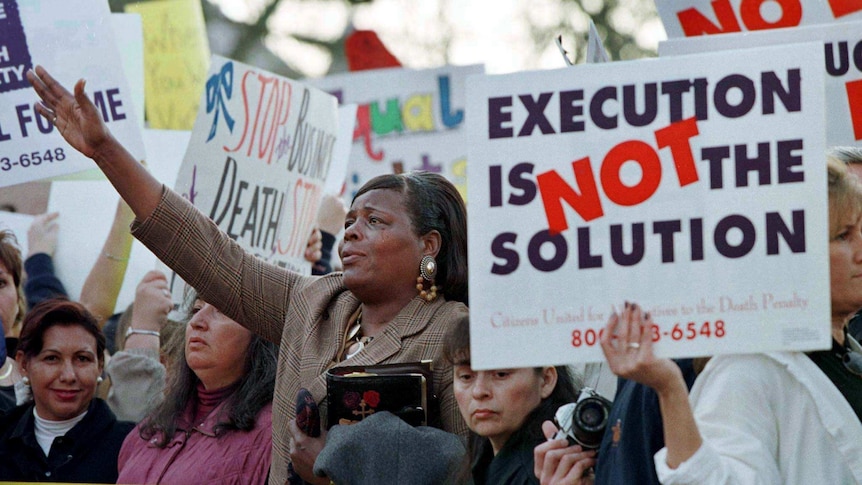 People protest the death penalty outside a Texas prison