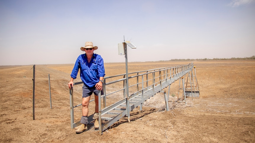 Farmer Martin Sullivan stands on the edge of one of his empty water storage dams in October 2019.