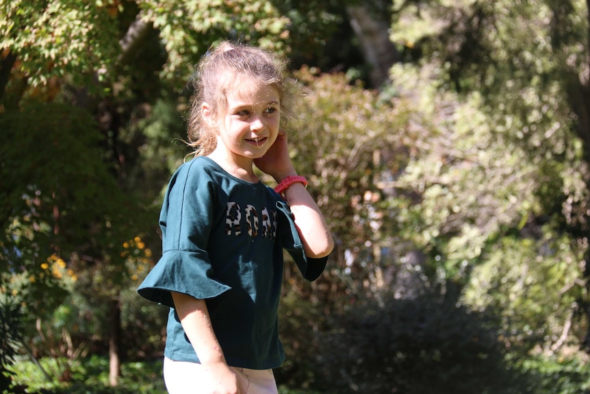 Evie Clark stands in her backyard.