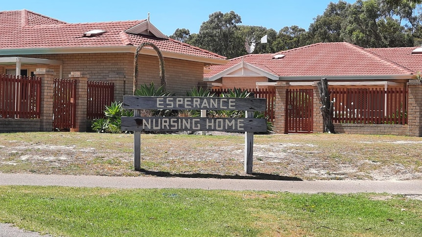 A wooden sign that says "Esperance Nursing Home" outside a complex of brick buildings.
