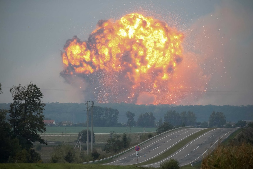 A huge explosion rises on the skyline in the town of Kalynivka.