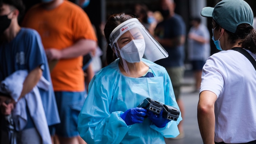 A healthworker in Sydney wearing a face shield at a testing clinic